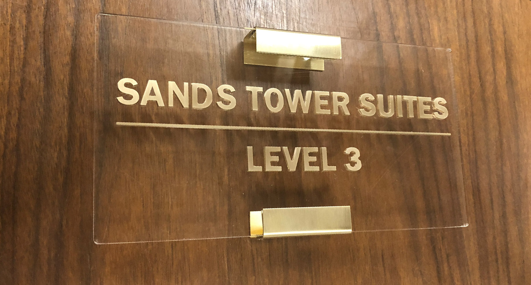 Brass letters on clear acrylic