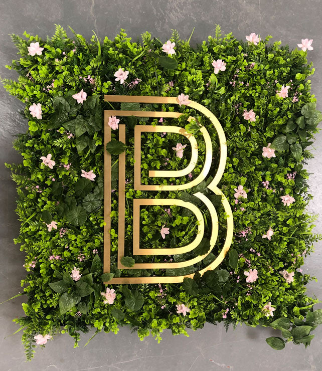 Brass sign letter on living wall