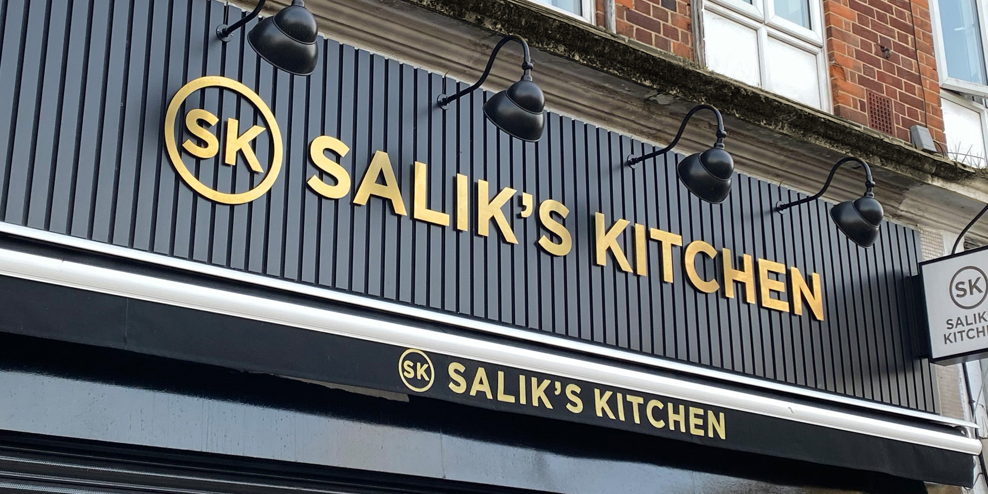 Gold 3D Letters on slatted black boards