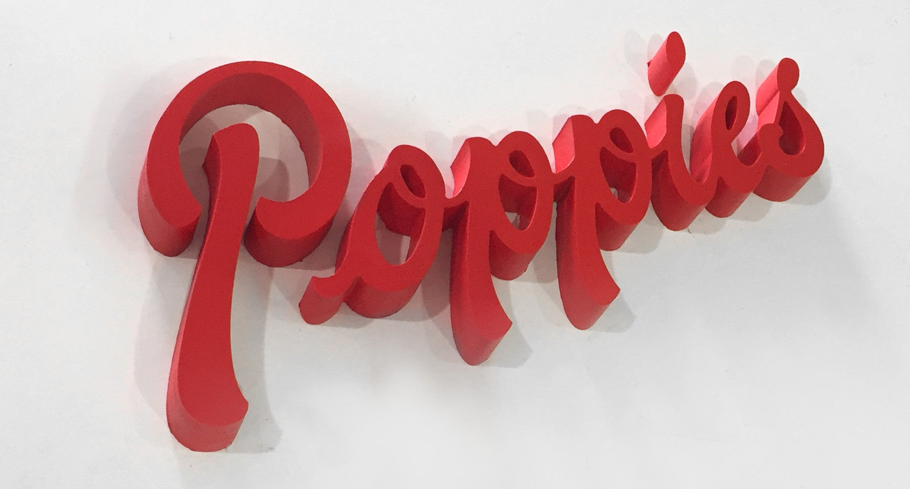 Red painted letters in a script font